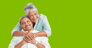 An elderly Latino couple embraces